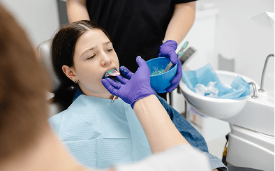 Dentist taking teeth impression