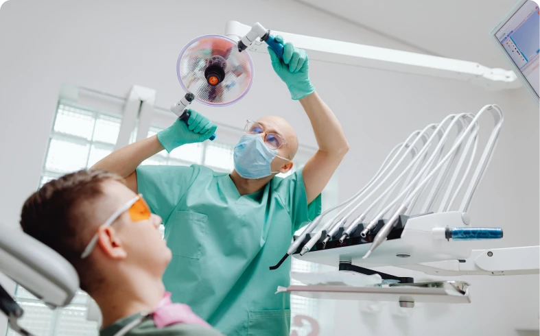 Patient in dentist's chair with protective eyewear